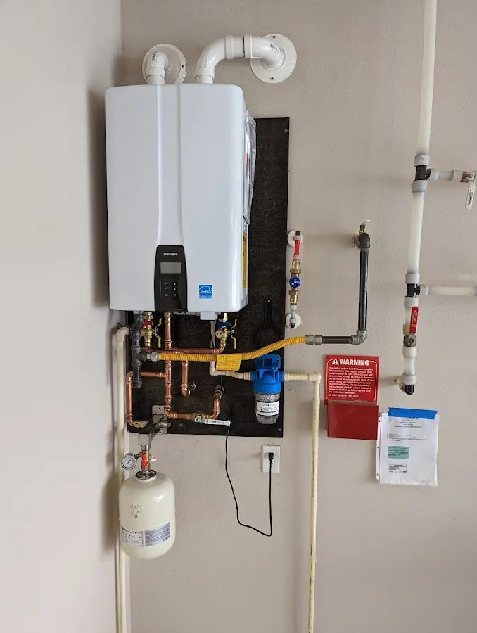 Professional plumber installing copper piping in a Twin Lakes home